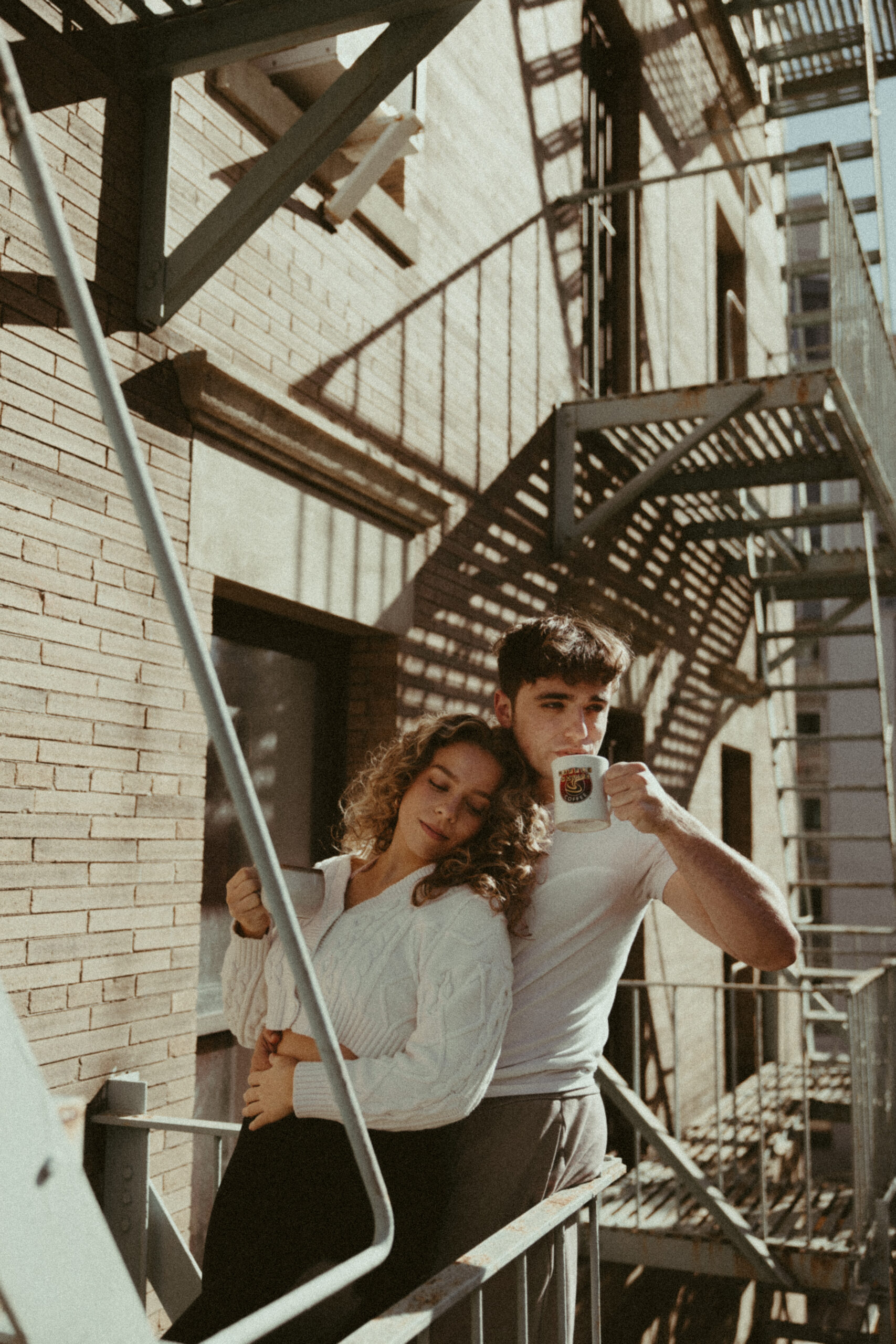 nyc couples photoshoot in an apartment on the fire escape
