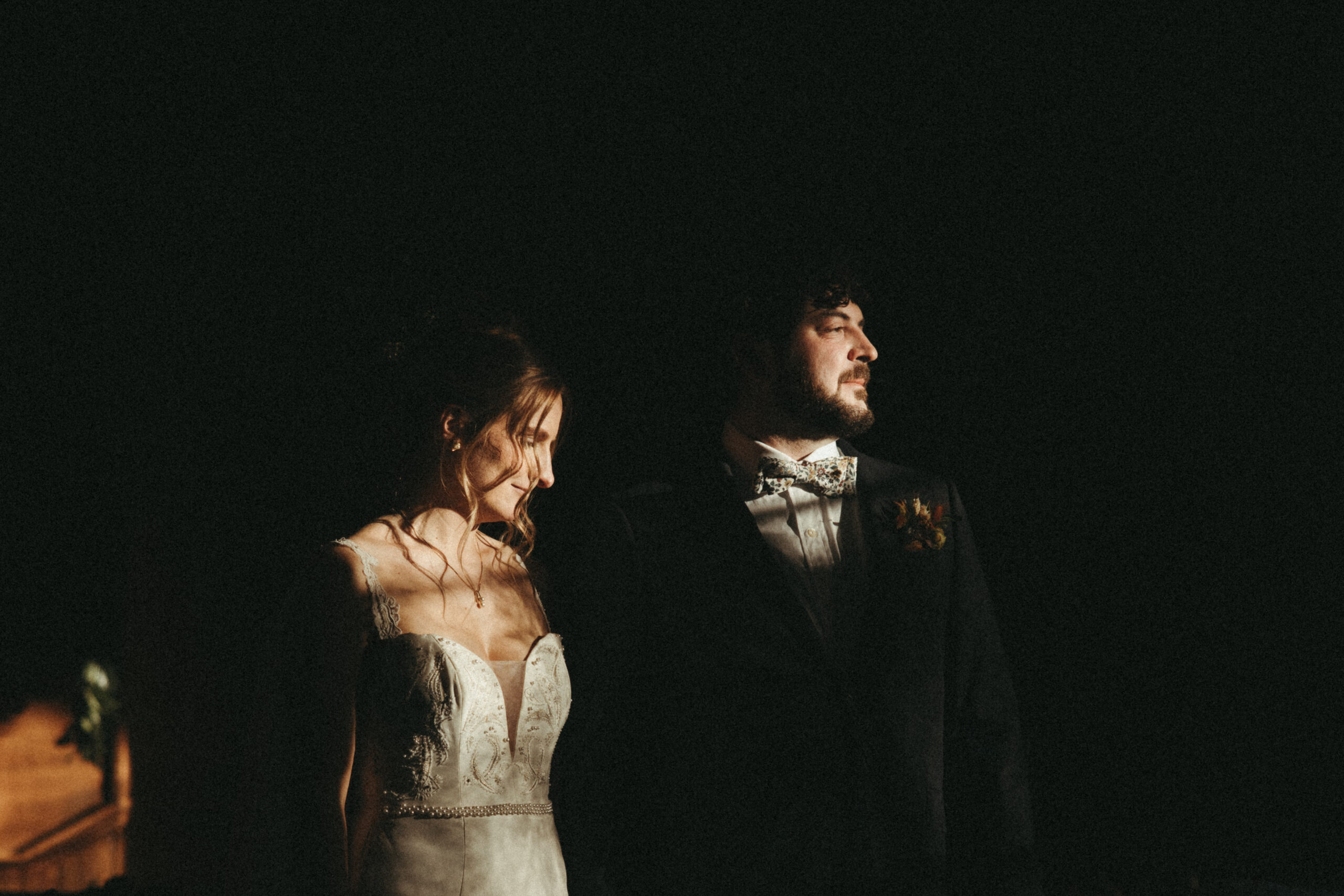 moody harsh light bride and groom portraits in a chapel