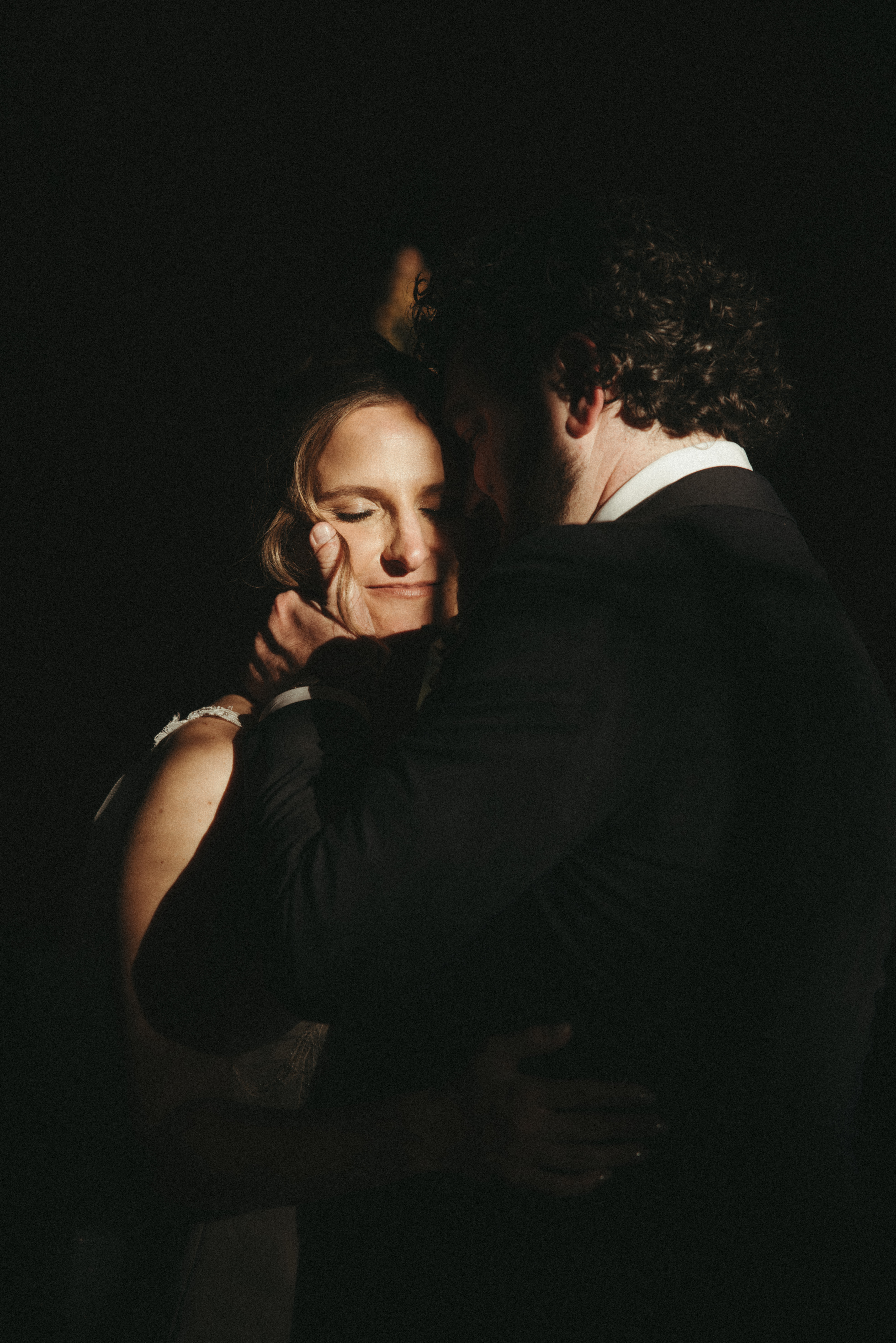 moody harsh light bride and groom portraits in a chapel